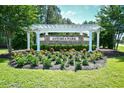 Astoria Park entrance sign surrounded by lush landscaping and a pergola at 2315 Blackthorn Dr., Conway, SC 29526