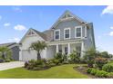 Beautiful home with a two-car garage, blue accents and lush landscaping at 2572 Brescia St., Myrtle Beach, SC 29579