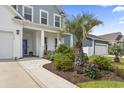 Inviting walkway to a lovely home with vibrant plants and a two-car garage at 2572 Brescia St., Myrtle Beach, SC 29579