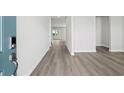 Bright hallway features durable floors, neutral paint, and access to multiple rooms at 2610 Tranquility Loop, Longs, SC 29568
