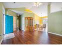 Inviting living room featuring hardwood floors, vaulted ceilings, and a bright blue front door at 264 La Patos Dr., Myrtle Beach, SC 29588