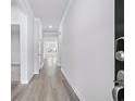 Bright hallway with wood-look flooring and white trim at 2700 Tranquility Loop, Longs, SC 29568