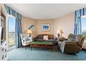 Comfortable living room with a sofa, recliner, chair, and a balcony with beautiful views at 2801 S Ocean Blvd. # 941, North Myrtle Beach, SC 29582