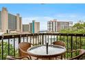 Enjoy the view from this cozy balcony, featuring a table and chairs for relaxing outdoors at 310 73Rd Ave. N # 5B, Myrtle Beach, SC 29572