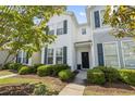 Inviting two-story townhome with well-maintained landscaping and a cozy front porch at 314 Kiskadee Loop # 8-C, Conway, SC 29526