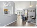 Open-concept living room with wood floors flowing into the dining area and kitchen at 3468 Trailside Dr., Little River, SC 29566