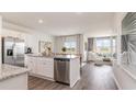 Open-concept kitchen featuring white cabinets, stainless steel appliances, and granite countertops at 3599 Ashridge Way, Conway, SC 29526