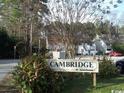 Street view of Cambridge At Jamestown community sign surrounded by trees at 411 Cambridge Circle # D5, Murrells Inlet, SC 29576
