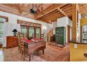 Open floor plan dining area with exposed beams, rustic furniture, and bright natural light at 4131 Gunter Lake Rd., Galivants Ferry, SC 29544