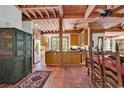 Rustic kitchen with exposed beam ceiling, terra cotta floors, and a large kitchen island at 4131 Gunter Lake Rd., Galivants Ferry, SC 29544