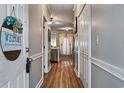 Inviting hallway with wood floors leads to the main living space, showing off a clean and well-maintained entryway at 4251 Hibiscus Dr. # 202, Little River, SC 29566