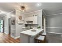 Charming kitchen features a breakfast bar with stool seating and easy transition into living space at 4251 Hibiscus Dr. # 202, Little River, SC 29566
