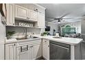 Cozy kitchen with white countertops and stainless steel dishwasher providing a clean and functional cooking space at 4251 Hibiscus Dr. # 202, Little River, SC 29566