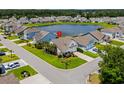 Aerial view of home with manicured lawn and pond access in a quiet neighborhood at 450 Oaklanding Ln., Murrells Inlet, SC 29576