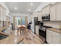 Well-lit kitchen with stainless steel appliances, granite countertops, and a dining area at 450 Oaklanding Ln., Murrells Inlet, SC 29576