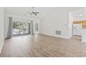 Bright living room featuring wood floors, a ceiling fan, and a sliding glass door to a patio at 50 Turning Stone Blvd. # 7, Murrells Inlet, SC 29576