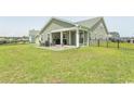 Expansive backyard with a patio and outdoor seating area, perfect for relaxation and entertaining at 5059 Sundrop Ln., Little River, SC 29566