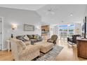 Bright and airy living room boasts hardwood floors, neutral walls, and seamless access to the kitchen and dining area at 521 Bay Drive Ext., Garden City Beach, SC 29576