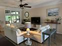 Bright living room with plush sofas, ceiling fan, and views of the outdoors at 5718 Herring Gull Circle, North Myrtle Beach, SC 29582