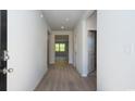 Inviting entryway with light wood flooring and crisp white walls provides a glimpse into the spacious layout at 585 Strawberry Field Way, Galivants Ferry, SC 29544