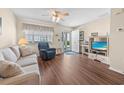 Comfortable living room with wood floors, a ceiling fan, and access to an outside patio at 613 S 2Nd Ave. # 21D, North Myrtle Beach, SC 29582