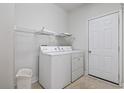 Practical laundry room with a washer, dryer, shelving and easy access to the outside at 618 5Th Ave. S, North Myrtle Beach, SC 29582