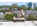 Aerial view of a multi-story condo complex surrounded by trees, buildings, and a beach backdrop at 6813 Porcher Dr. # 25, Myrtle Beach, SC 29572