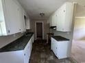 Kitchen with white cabinets, marbled counter tops, and updated flooring at 76 Lyerly Rd., Hemingway, SC 29554