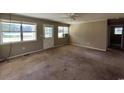 Bright living room with natural light, neutral walls and carpeted floors at 76 Lyerly Rd., Hemingway, SC 29554