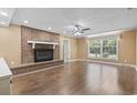 Spacious living room features a brick fireplace and ample natural light from a large window at 1043 South Main St., Aynor, SC 29511