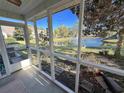 View from screened porch featuring a scenic pond view and lush greenery, creating a serene outdoor living space at 107 Pawleys Place Dr. # 107, Pawleys Island, SC 29585
