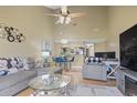 Open-concept living room with dining area features modern furniture, high ceiling and ample lighting at 1100 Possum Trot Rd. # C-203, North Myrtle Beach, SC 29582
