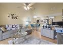 Open-concept living room with dining area features modern furniture, high ceiling and ample lighting at 1100 Possum Trot Rd. # C-203, North Myrtle Beach, SC 29582