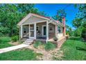 Charming home with a covered porch and brick foundation surrounded by green grass and trees at 112 Blue Gull Dr., Conway, SC 29526