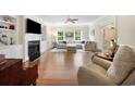 Bright living room with fireplace, built-in bookshelves and comfortable sofas, creating an inviting and stylish atmosphere at 113 Trotter Trail, Georgetown, SC 29440