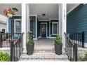 Welcoming front porch with classic columns and decor, offering a cozy outdoor space at 1131 East Isle Of Palms, Myrtle Beach, SC 29579