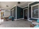 Charming front porch features a seating area with blue cushions and an inviting entry at 1131 East Isle Of Palms, Myrtle Beach, SC 29579