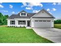 Charming home with a two-car garage, manicured lawn, and lush green surroundings at 142 Temple Dr., Aynor, SC 29511