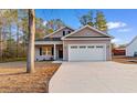 Charming single-story home featuring a two-car garage, manicured lawn, and inviting front porch at 146 Temple Dr., Aynor, SC 29511