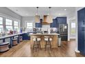 Modern kitchen featuring dark cabinetry, a center island, and stainless steel appliances at 1512 Riverside Dr., Sunset Beach, NC 28468