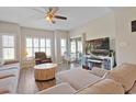 Comfortable living room featuring a ceiling fan, hardwood floors, and sliding glass doors to a balcony at 1551 Spinnaker Dr. # 5913, North Myrtle Beach, SC 29582