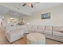 Bright living room showcasing a large sectional sofa, hardwood floors, and an open view of the kitchen at 1551 Spinnaker Dr. # 5913, North Myrtle Beach, SC 29582