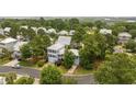 A captivating aerial view of a neighborhood showcasing lush landscaping and beautiful homes with silver metal roofs at 175 Summer Wind Loop, Murrells Inlet, SC 29576