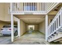 Designated covered parking spot with parking signage and stairs leading to residence at 1912 Goose Creek Rd. Sw # 4302, Ocean Isle Beach, NC 28469