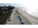 Aerial view of Myrtle Beach with beach umbrellas along the coast line at 201 76Th Ave. N # E3, Myrtle Beach, SC 29577