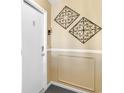 Hallway entrance featuring neutral wall decor and a unit door, showcasing a clean and modern aesthetic at 210 Double Eagle Dr. # B-2, Surfside Beach, SC 29575