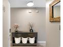Hallway view of a console table, decor, and a mirror, offering a glimpse into the home's stylish interior at 210 Double Eagle Dr. # B-2, Surfside Beach, SC 29575