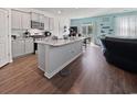 Bright, open kitchen featuring gray cabinets, stainless appliances, granite countertops, and a large island at 2230 Ainsley Dr., Little River, SC 29566