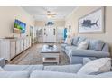 Bright living room with beach-themed decor, comfortable seating, and wood-look flooring at 2405 Duffy St., North Myrtle Beach, SC 29582