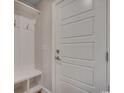 Entrance with coat rack featuring storage bench, hooks, and paneled door at 2599 Woodcreek Ln., Conway, SC 29527